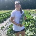 Lucy picking zucchini.